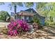 Charming two-story home with a welcoming front porch and vibrant azalea bushes at 702 Hazel Ave, Kannapolis, NC 28083