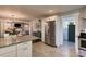 Open-concept kitchen with granite counters, stainless steel appliances and a view into the dining and living area at 702 Hazel Ave, Kannapolis, NC 28083