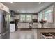 Modern kitchen featuring stainless steel appliances, granite countertops, and white cabinetry at 702 Hazel Ave, Kannapolis, NC 28083