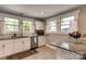 Bright kitchen boasts stainless appliances, white cabinets, and granite countertops at 702 Hazel Ave, Kannapolis, NC 28083