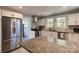 Bright kitchen with stainless steel appliances, granite counters, subway tile backsplash, and ample counter space at 702 Hazel Ave, Kannapolis, NC 28083