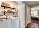 Well-organized laundry room with modern washer and dryer, and convenient open shelving at 702 Hazel Ave, Kannapolis, NC 28083