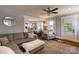 Bright living room with hardwood floors, grey sofa, and seamless open floor plan at 702 Hazel Ave, Kannapolis, NC 28083