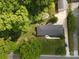 Aerial view of a well-maintained home surrounded by lush greenery, a driveway and street access at 7048 Delta Lake Dr, Charlotte, NC 28215