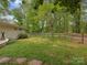 Spacious backyard featuring a wooden fence and lush greenery, offering privacy and natural beauty at 7048 Delta Lake Dr, Charlotte, NC 28215