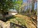 A beautiful backyard with wooden fence and a grass-covered yard surrounded by mature trees offers privacy at 7048 Delta Lake Dr, Charlotte, NC 28215