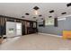 Finished basement features gray walls, acoustic ceiling tiles, and a walkout door at 7048 Delta Lake Dr, Charlotte, NC 28215