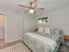 Comfortable bedroom featuring a large bed, neutral walls, a ceiling fan, and a window overlooking the outdoors at 7048 Delta Lake Dr, Charlotte, NC 28215