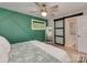 Stylish bedroom showcasing a unique accent wall, modern ceiling fan, and access to an adjacent room at 7048 Delta Lake Dr, Charlotte, NC 28215