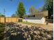 Exterior view of a house with a fenced backyard and mature trees for privacy at 7048 Delta Lake Dr, Charlotte, NC 28215
