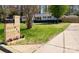 Well-maintained single-story home with a lush front yard, enhanced by a decorative mailbox and modern fence at 7048 Delta Lake Dr, Charlotte, NC 28215