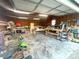 Cluttered garage with tools, equipment and shelving providing ample storage space at 7048 Delta Lake Dr, Charlotte, NC 28215