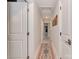 Well-lit hallway with a decorative rug and doors on either side, leading to various rooms in the home at 7048 Delta Lake Dr, Charlotte, NC 28215