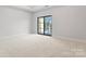 Airy bedroom with plush carpeting and a large sliding glass door for natural light at 710 Falling Oak Aly # 17, Huntersville, NC 28078