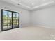Bright bedroom featuring soft carpeting and sliding glass doors leading to a balcony at 710 Falling Oak Aly # 17, Huntersville, NC 28078