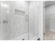 Modern shower with marble-style tile, glass door, and built-in shelf at 710 Falling Oak Aly # 17, Huntersville, NC 28078
