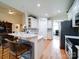 Open kitchen featuring a breakfast bar, white cabinets, granite counters, and stainless appliances at 7184 Seagrass Cir, Denver, NC 28037