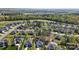 Lovely aerial view of a beautiful neighborhood featuring manicured lawns, mature trees, and neighborhood pool at 7186 Barleywood Dr, Locust, NC 28097