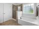 Clean bathroom featuring a soaking tub and a separate tiled shower at 7186 Barleywood Dr, Locust, NC 28097