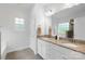 Bright bathroom features a double-sink vanity with granite countertops at 7186 Barleywood Dr, Locust, NC 28097