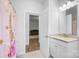 Bathroom with a view to another room, featuring a granite countertop, decorative shower curtain, and toilet at 7186 Barleywood Dr, Locust, NC 28097