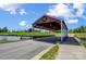 Scenic view of the covered bridge on the golf course, adding a touch of charm and exclusivity to the community at 7186 Barleywood Dr, Locust, NC 28097