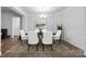 Elegant dining room featuring wainscoting, a modern chandelier, and stylish decor, creating a sophisticated space at 7186 Barleywood Dr, Locust, NC 28097