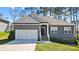 Charming one-story home with a gray exterior, white trim, an attached garage, and a well-manicured lawn at 7186 Barleywood Dr, Locust, NC 28097
