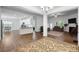 Open-concept living room and kitchen features hardwood floors and natural light at 7186 Barleywood Dr, Locust, NC 28097