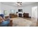 Bright living room features a fireplace, piano and access to backyard at 7186 Barleywood Dr, Locust, NC 28097