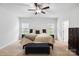 Carpeted bedroom has bright windows and a comfortable bench at 7186 Barleywood Dr, Locust, NC 28097