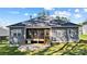 Back of the house with a screened in porch featuring a grill, along with a wide grassy yard at 7186 Barleywood Dr, Locust, NC 28097