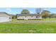 Backyard of a home with a well-manicured lawn, detached garage, and a patio area at 775 Bolick Rd, Fort Mill, SC 29707