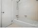 Clean white bathroom featuring a bathtub with shower and white tiles for a serene space at 819 Old Dutch W Rd, Indian Trail, NC 28079