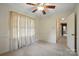 Comfortable bedroom with a ceiling fan, neutral carpeting, and view leading into the hallway and kitchen at 819 Old Dutch W Rd, Indian Trail, NC 28079