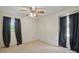 Bedroom featuring a ceiling fan and dark curtains adding a touch of elegance to the serene space at 819 Old Dutch W Rd, Indian Trail, NC 28079