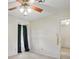 Clean and open bedroom featuring light walls, wallpaper accent wall, ceiling fan, and neutral carpeting at 819 Old Dutch W Rd, Indian Trail, NC 28079