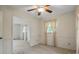 Inviting bedroom featuring a ceiling fan, neutral carpeting, and a view into an adjacent room at 819 Old Dutch W Rd, Indian Trail, NC 28079
