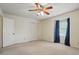 Bedroom with neutral walls and carpet, a ceiling fan, and a window with blue curtains at 819 Old Dutch W Rd, Indian Trail, NC 28079