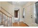 Bright entryway with hardwood floors, stairs, and a glimpse into a room with built-in bookshelves at 819 Old Dutch W Rd, Indian Trail, NC 28079