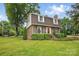 Lovely brick home surrounded by greenery and manicured bushes, providing a welcoming and picturesque facade at 819 Old Dutch W Rd, Indian Trail, NC 28079