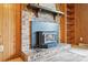 Close-up of brick fireplace with a black stove and decorative mantel at 819 Old Dutch W Rd, Indian Trail, NC 28079