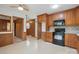 Open kitchen design with wood cabinets, black appliances, and breakfast area at 819 Old Dutch W Rd, Indian Trail, NC 28079