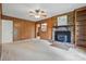 Cozy living room with wood paneling, brick fireplace, and built-in shelving at 819 Old Dutch W Rd, Indian Trail, NC 28079