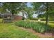 Landscaped yard with a play structure and trees at 819 Old Dutch W Rd, Indian Trail, NC 28079