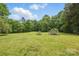 View of the well-manicured yard with mature trees and lush green grass at 819 Old Dutch W Rd, Indian Trail, NC 28079