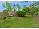 Expansive backyard with well-maintained lawn and mature trees, offering privacy and a natural setting at 8605 Ducksbill Dr, Charlotte, NC 28277