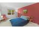Comfortable bedroom with a blue bed, ample natural light, and minimalist decor for a relaxing retreat at 8605 Ducksbill Dr, Charlotte, NC 28277