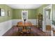 Bright dining room with hardwood floors, table and chairs, illuminated by a chandelier and natural light at 8605 Ducksbill Dr, Charlotte, NC 28277
