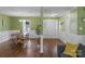Inviting entryway with hardwood floors leading to a dining area and featuring a white front door at 8605 Ducksbill Dr, Charlotte, NC 28277